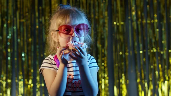 Stylish Trendy Young Child Girl at Disco Party Cyberpunk Club Eating Big Chocolate Bar Sweet Candy