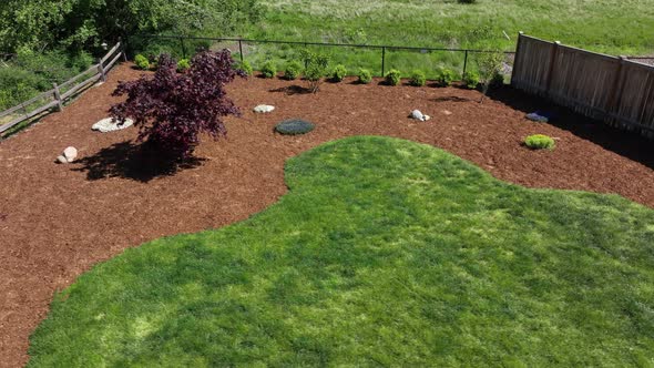 Aerial of a fresh bed of bark in a landscaped backyard.