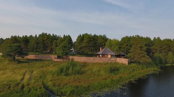 House In Woods Near Lake