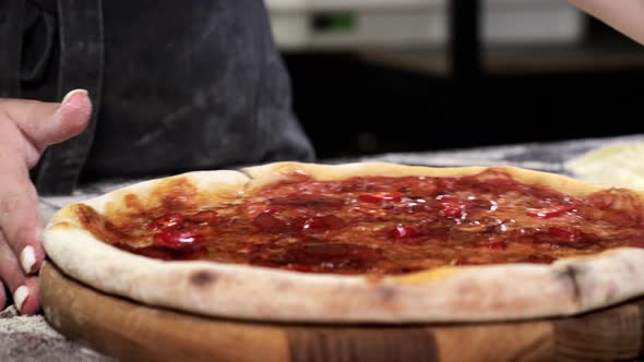 Freshly baked appetizing pizza, cut into slices with a pizza cutter. Pizza knife.