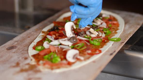 Chef preparing the pizza.