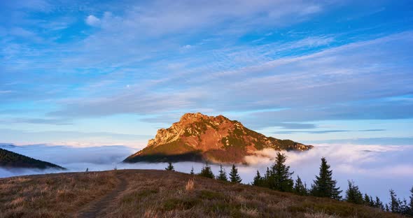 Inverse clouds moving around the rocky mountain peak in the national park.