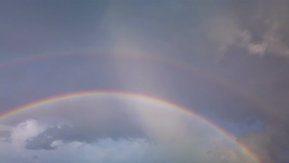 Double rainbow on rainy sky