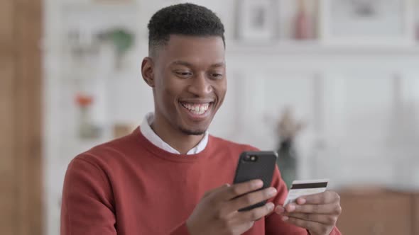 Portrait of African Businessman making Online Payment on Smartphone