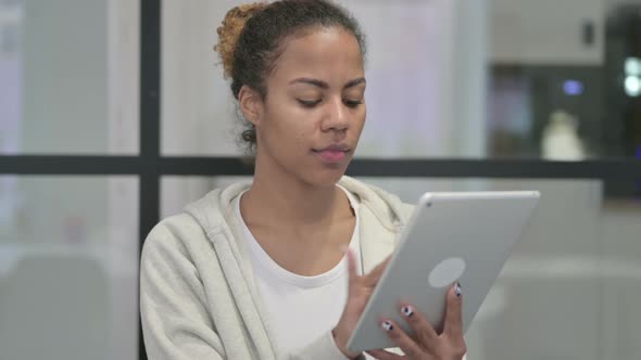 African Woman Using Tablet in Office