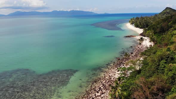 Green Jungle and Stony Beach Near Sea. Tropical Rainforest and Rocks Near Calm Blue Sea on White