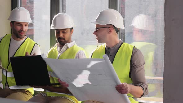 Male Architects in Helmets with Laptop at Office