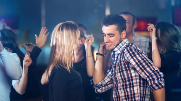 Young Happy Couple is Dancing at a Party