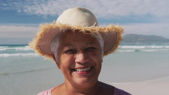 Portrait of mixe race senior woman smiling at the beach