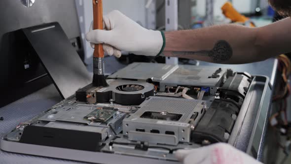 Closeup Shot of Male Hands Working on Disassembling and Cleaning Circuit Board in Laptop Using Brush