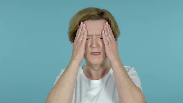 Old Woman with Headache Isolated on Blue Background