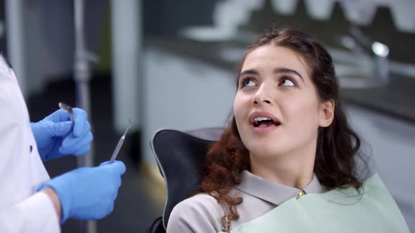 Cheerful Female Patient Talking to Dentist