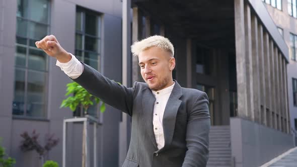 Blond Man in Stylish Wear Which Having Fun on Electric Scooter Outdoors On Sunny Day