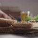 Man Put Steak Slices on on Small Ciabatta Bun for Sandwich on Kitchen Countertop - VideoHive Item for Sale