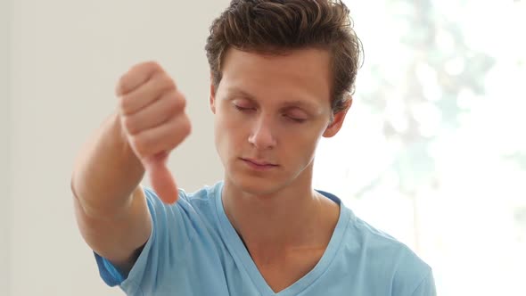 Thumb Down by Young Man, Indoor Portrait