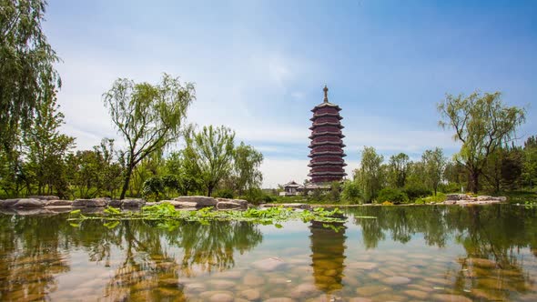 Wooden Pagoda Under The Blue Sky In Front Of The Pond