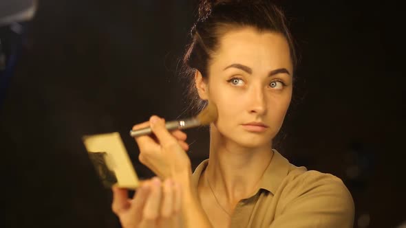 Caucasian Woman Apllying Powder on Her Face