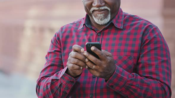 Senior Middle Aged Black Man Holding Modern Device Smart Phone Using Mobile App Old Elderly Person