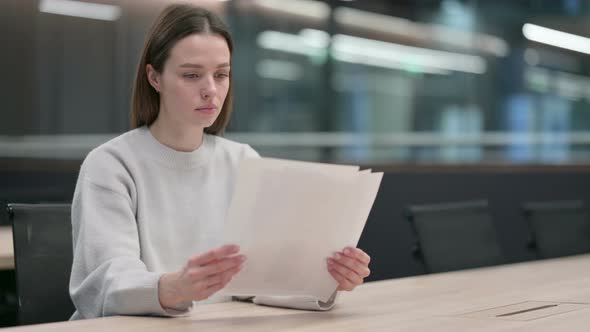 Woman Reading Documents at Work