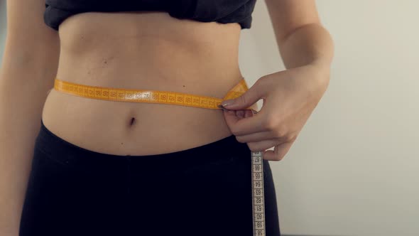 Woman Measuring Waist Progress Weight Loss. Girl Measuring Waist With Measure Tape. Measuring Tape.