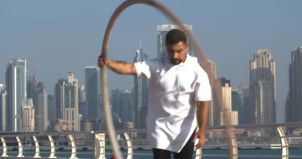 Close Up of a Wheel Gymnast Spinning a Hoop Around Himself Dubai Marina