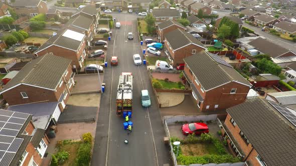 Aerial View, footage of Dustmen putting recycling waste into a garbage truck, Bin men, refuse collec