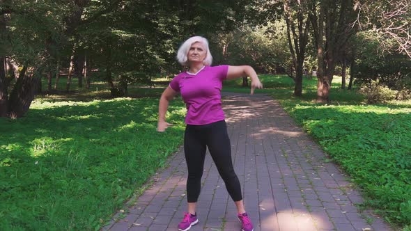 Retired woman doing warm-up before training in the park.