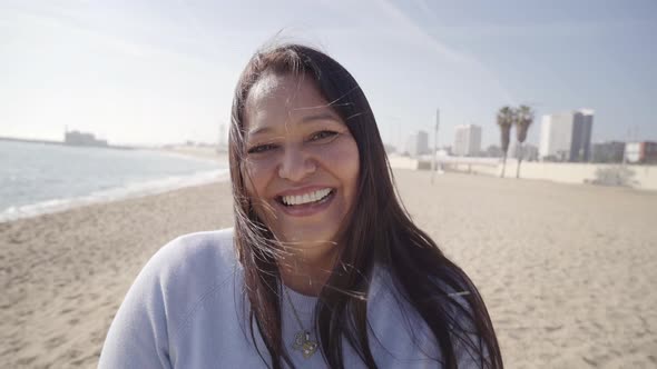 Portrait Happy Middle Aged Latin Woman Laughing Enjoying Successful Beach Lifestyle in City Real