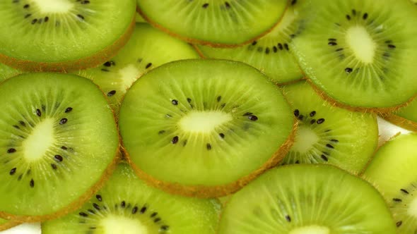 Top view Rotate of Transparent Slice of kiwi fruit on white background, Close up fresh kiwi