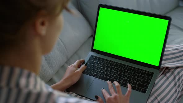 Woman Waving Green Laptop at Home Closeup