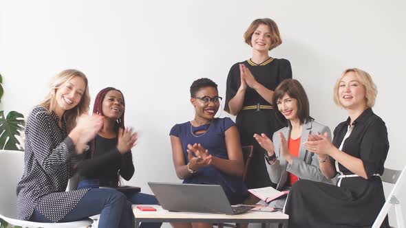 Portrait of Multi-ethnic Female Group Applauding Their Success While Looking at Camera