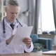 Doctor Reading Medical Report - VideoHive Item for Sale