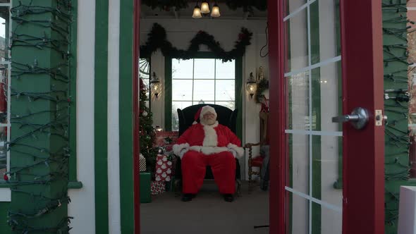 View of Santa sitting in holiday booth