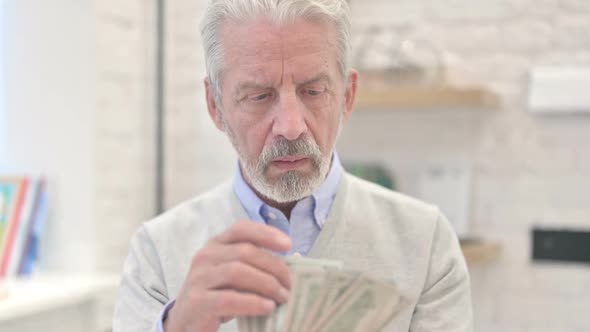 Worried Old Man Counting Dollars Money