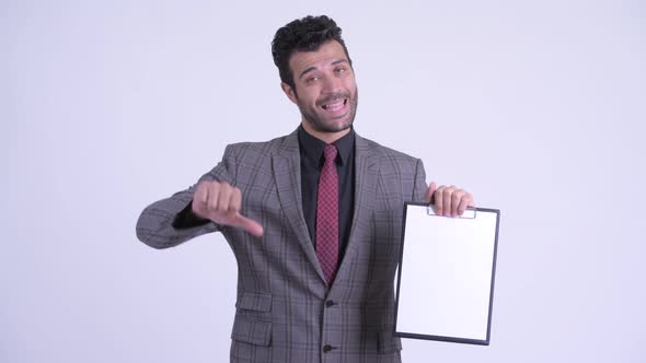 Stressed Bearded Persian Businessman Showing Clipboard and Giving Thumbs Down