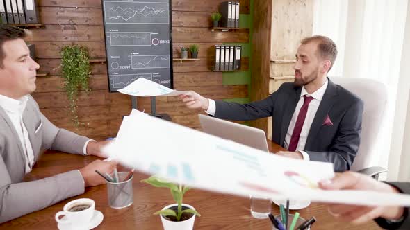 Businessman in Suit Working on Laptop in the Conference Room