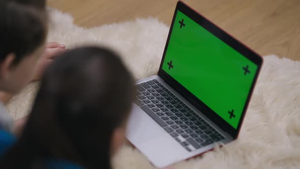 Chromakey Laptop Screen with Relaxed Teenage Boy and Girl Watching