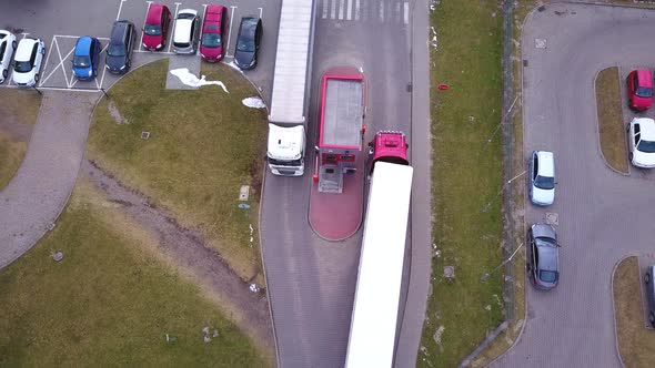 Truck is Driving from and into Logistics Warehouse. Aerial shot. Drone-