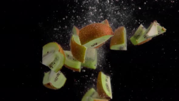 Kiwi Pieces Falling into Water Super Slowmotion, Black Background, lots of Air Bubbles, 4k240fps