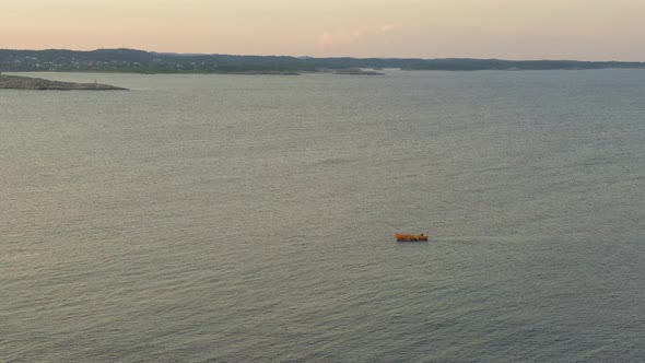 Boat Sailing Across Inlet Water In Store Torungen Island In Arendal, Norway. aerial