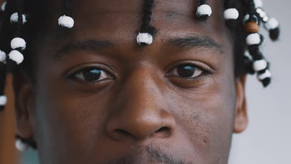 Close Up Eyes of Confident African American Black Man with Braided Hear Looking Into the Camera