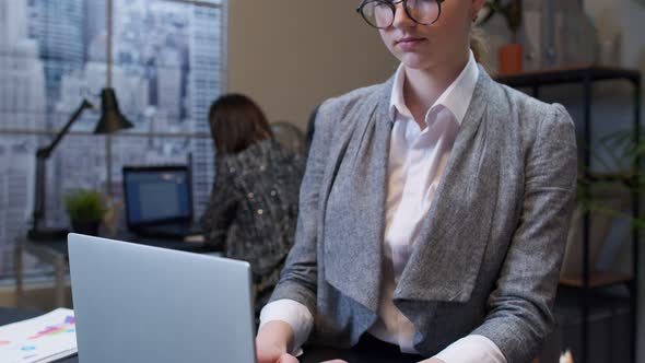 Thoughtful Young Business Woman Working on Laptop in Office Wondering Difficult Solution Imagining