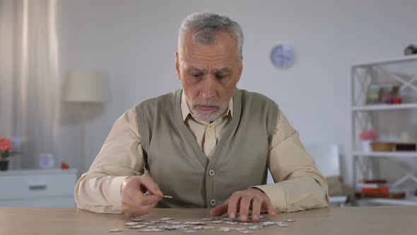 Old Man Exercises With Puzzle