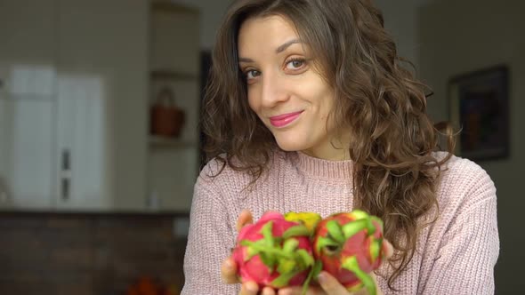 Young Girl is Holding Two Fresh Ripe Organic Dragon Fruits or Pitaya Pitahaya