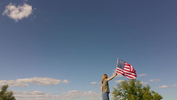 Woman Holds Waving American Flag