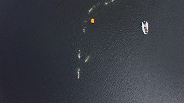 People Doing Triathlon at Sea