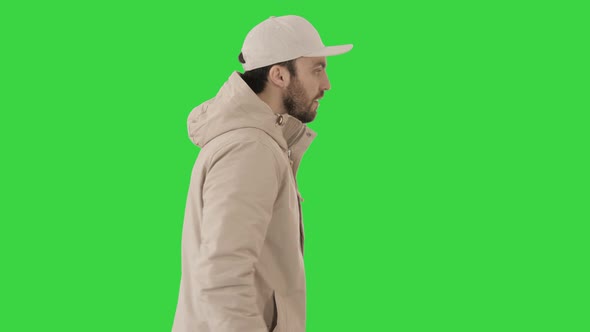 Handsome Fashionable Man in a Winter Stylish Coat Walking on a Green Screen, Chroma Key.