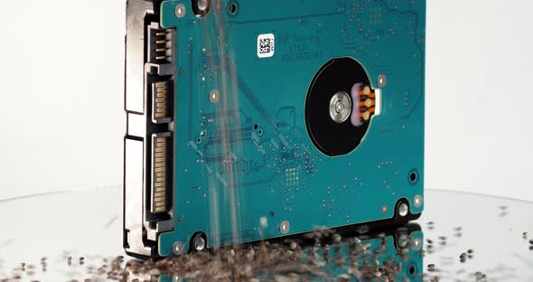 Closeup Shot of Chia Seeds Falling on a Rotating Table with a Hdd in the Middle