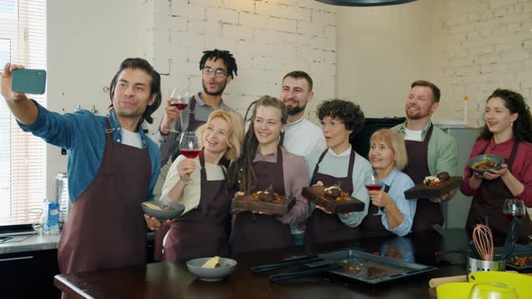 Culinary School Students Taking Selfie with Smartphone Camera Holding Dishes