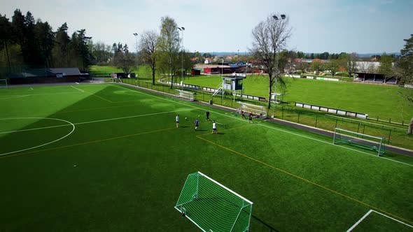 Aerial view of people playing football tennis in the Summer.